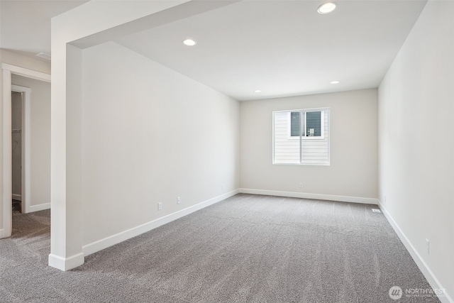 carpeted spare room featuring recessed lighting and baseboards