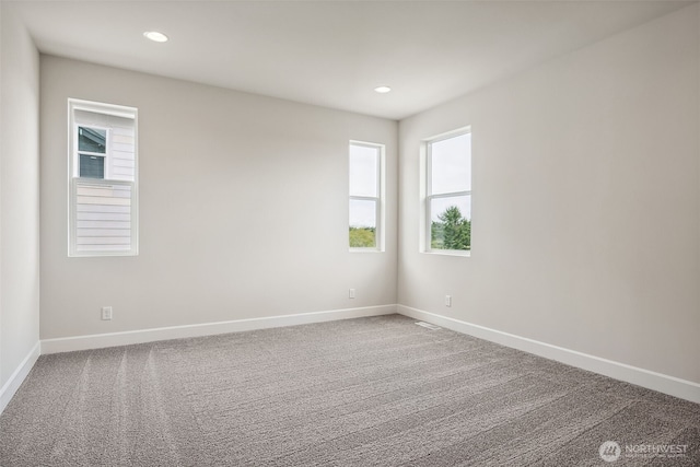 carpeted empty room with baseboards, recessed lighting, and visible vents
