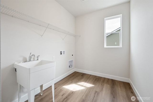 clothes washing area featuring washer hookup, laundry area, electric dryer hookup, wood finished floors, and baseboards