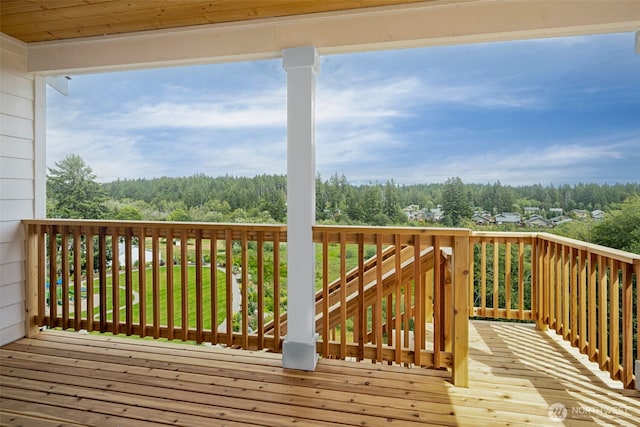 wooden terrace with a view of trees