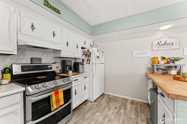 16 Harrison St, South Bend, WA 98586 - kitchen with freestanding refrigerator, white cabinetry, wood counters, and double oven range