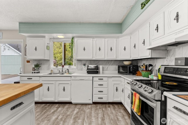 16 Harrison St, South Bend, WA 98586 - kitchen with a textured ceiling, stainless steel range with electric stovetop, a sink, dishwasher, and under cabinet range hood