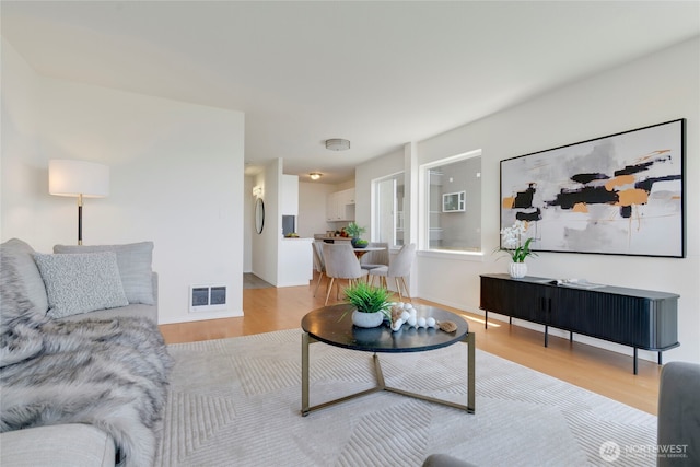 1156 Alki Ave SW Unit 105, Seattle, WA 98116 - living area featuring visible vents and light wood-style floors