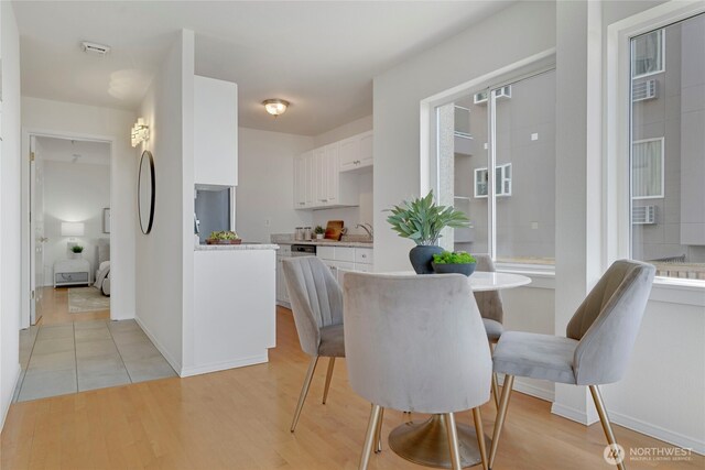 1156 Alki Ave SW Unit 105, Seattle, WA 98116 - dining space featuring light wood-type flooring and baseboards