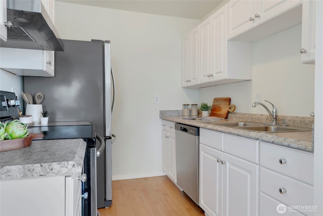 1156 Alki Ave SW Unit 105, Seattle, WA 98116 - kitchen featuring appliances with stainless steel finishes, a sink, ventilation hood, light wood-style floors, and white cabinetry