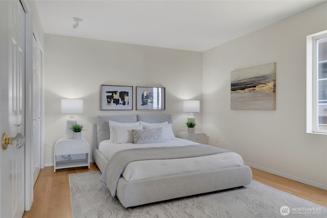 1156 Alki Ave SW Unit 105, Seattle, WA 98116 - bedroom featuring baseboards and light wood-style floors