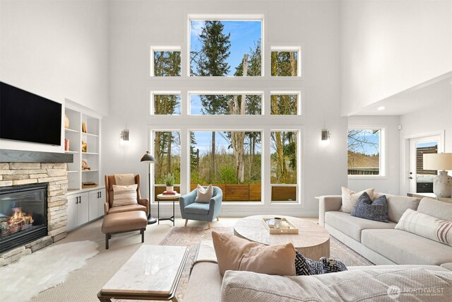 3679 Silver Oak Ct, Bellingham, WA 98226 - living area featuring a towering ceiling, built in features, and a fireplace