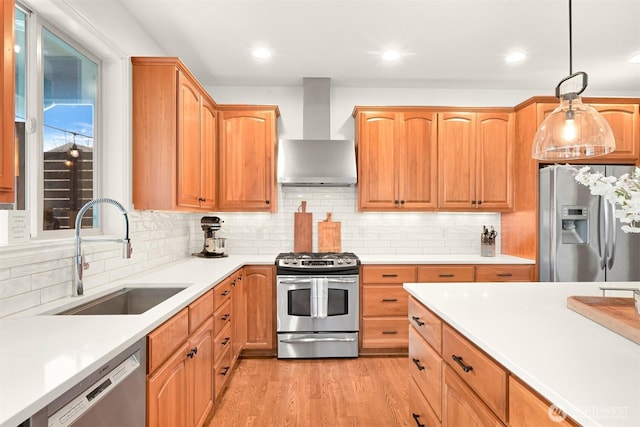 3679 Silver Oak Ct, Bellingham, WA 98226 - kitchen featuring a sink, light countertops, light wood-style flooring, wall chimney exhaust hood, and stainless steel appliances