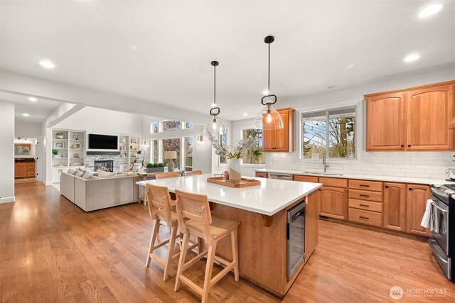 3679 Silver Oak Ct, Bellingham, WA 98226 - kitchen featuring stainless steel appliances, a center island, a sink, and tasteful backsplash
