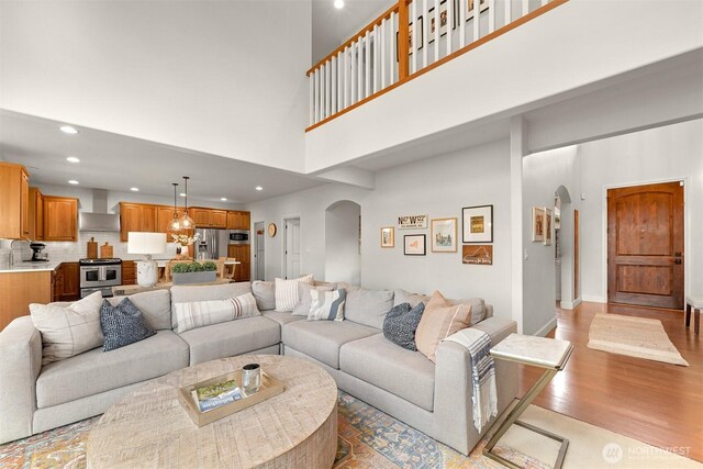 3679 Silver Oak Ct, Bellingham, WA 98226 - living room featuring light wood-style floors, arched walkways, a high ceiling, and recessed lighting