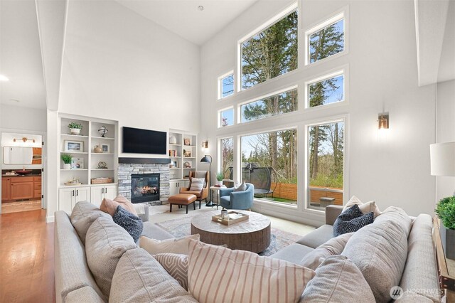 3679 Silver Oak Ct, Bellingham, WA 98226 - living area with high vaulted ceiling, a stone fireplace, and light wood-style flooring