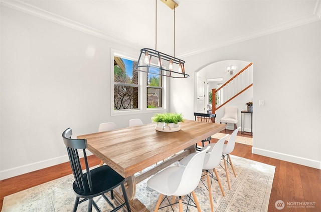 3679 Silver Oak Ct, Bellingham, WA 98226 - dining area featuring arched walkways, ornamental molding, baseboards, and stairs