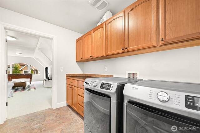 3679 Silver Oak Ct, Bellingham, WA 98226 - laundry area with stone finish floor, light colored carpet, visible vents, washing machine and dryer, and cabinet space
