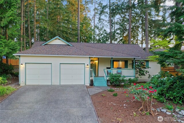 ranch-style house with a garage, a shingled roof, a porch, and driveway