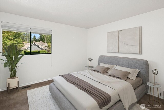 carpeted bedroom with baseboards and visible vents