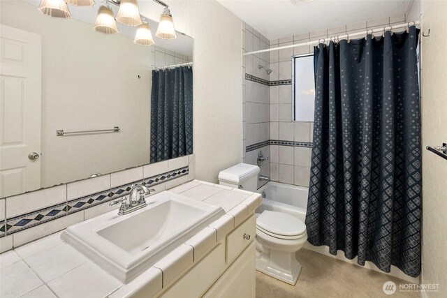 full bath with vanity, toilet, decorative backsplash, and shower / tub combo