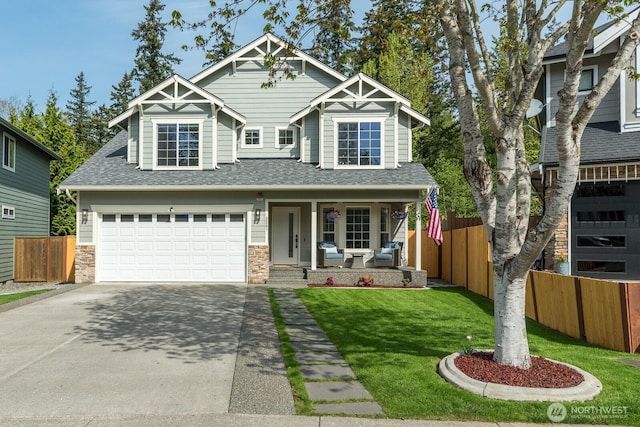 craftsman-style house with covered porch, driveway, a front yard, a garage, and fence