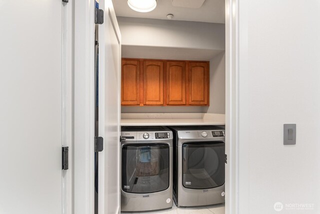 laundry room with washing machine and dryer and cabinet space