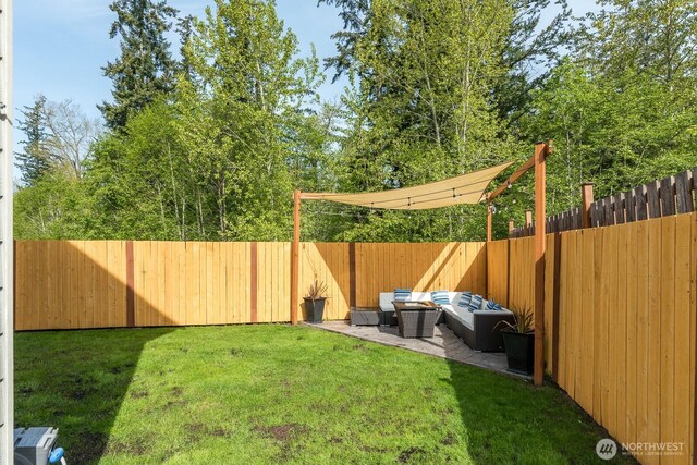 view of yard featuring a patio, a fenced backyard, and outdoor lounge area