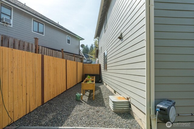 view of property exterior featuring fence and cooling unit