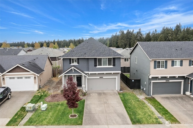 traditional-style home featuring roof with shingles, a residential view, a garage, a front lawn, and concrete driveway