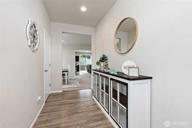 hall with recessed lighting, baseboards, and wood finished floors