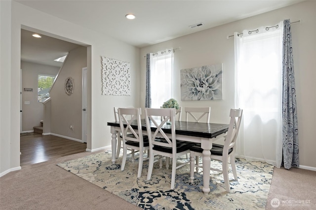 carpeted dining area featuring stairway, baseboards, recessed lighting, and visible vents