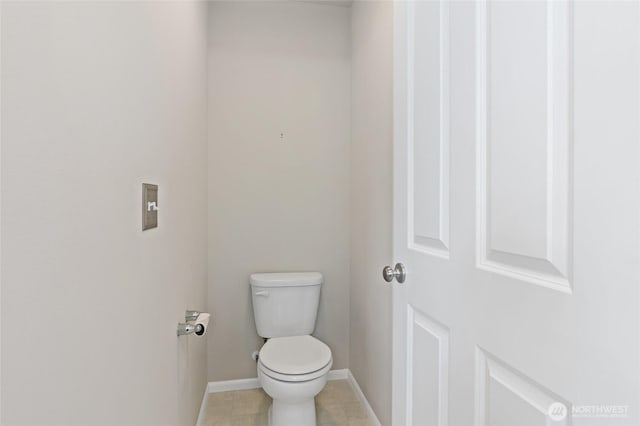 bathroom with toilet and baseboards
