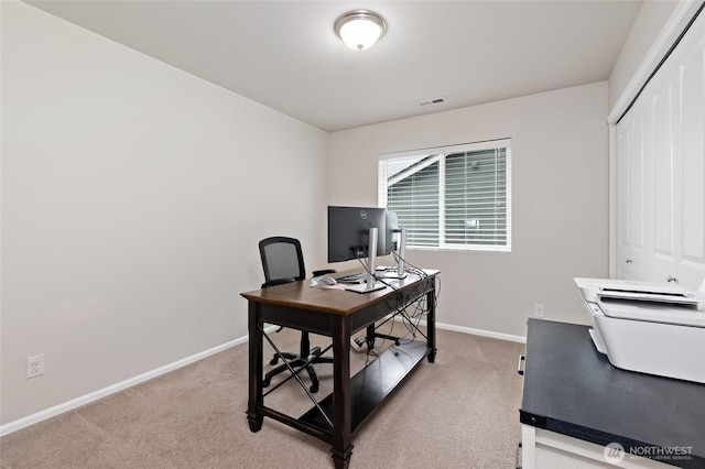 office area with baseboards, light colored carpet, and visible vents