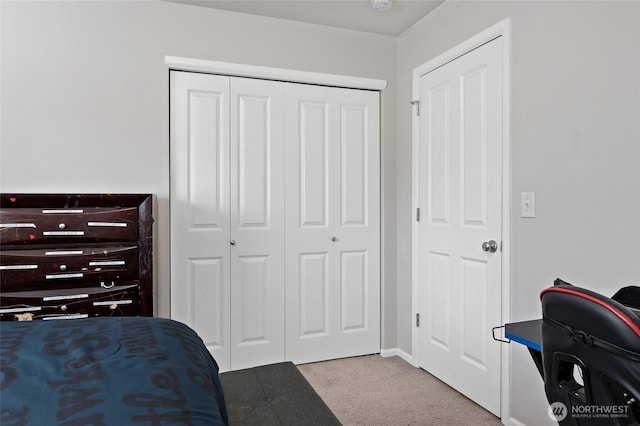 carpeted bedroom with a closet