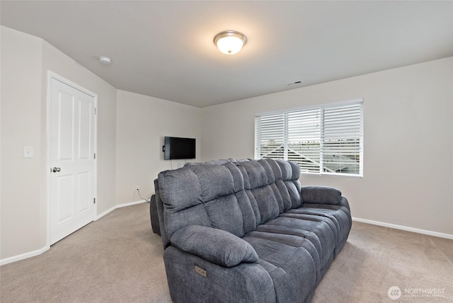 living room featuring baseboards, visible vents, and light colored carpet