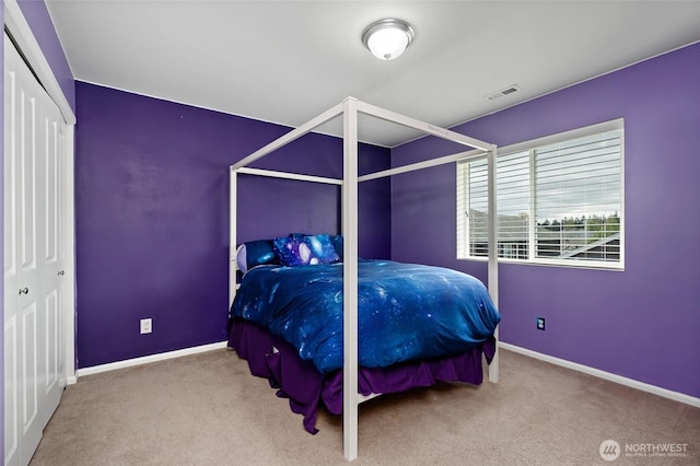 bedroom featuring baseboards, carpet flooring, and visible vents