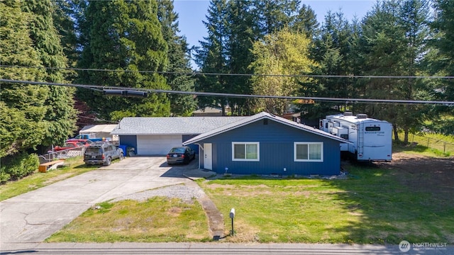 view of front of house with a front yard and concrete driveway