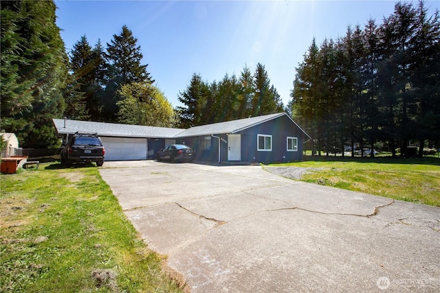 ranch-style house featuring a garage, driveway, and a front lawn
