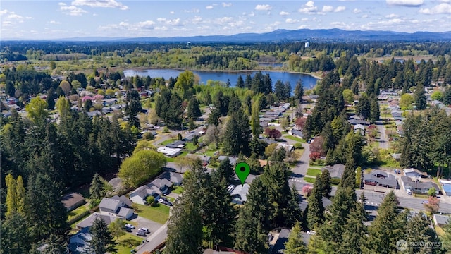 bird's eye view featuring a residential view, a view of trees, and a water and mountain view
