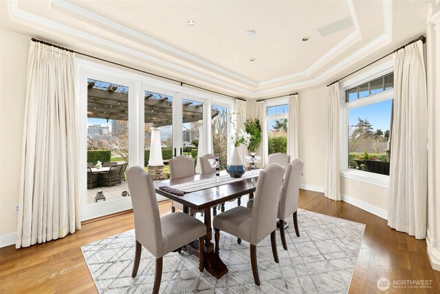 9676 Evergreen Dr, Bellevue, WA 98004 - dining area with a raised ceiling, ornamental molding, wood finished floors, and baseboards
