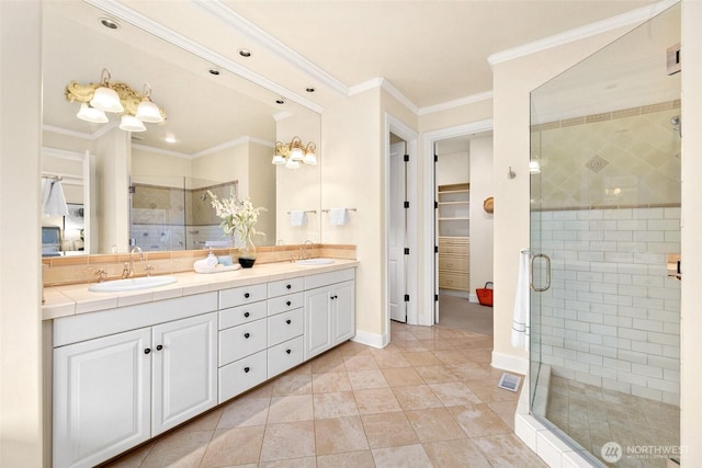 9676 Evergreen Dr, Bellevue, WA 98004 - bathroom with a shower stall, double vanity, a walk in closet, crown molding, and baseboards
