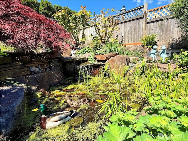9676 Evergreen Dr, Bellevue, WA 98004 - view of yard with a small pond and fence