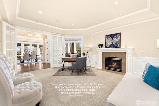 9676 Evergreen Dr, Bellevue, WA 98004 - carpeted living room featuring a raised ceiling, a high end fireplace, wainscoting, french doors, and crown molding