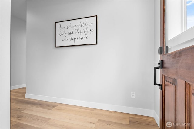empty room featuring baseboards and wood finished floors