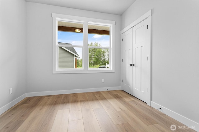 interior space featuring baseboards and light wood-type flooring
