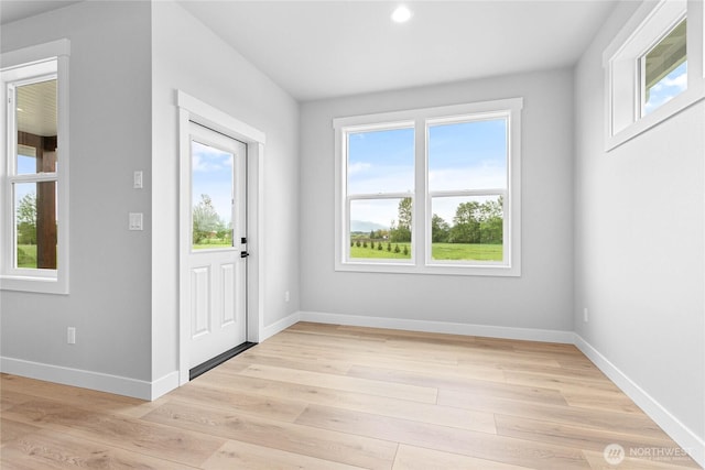 foyer entrance featuring baseboards, recessed lighting, and light wood-style flooring