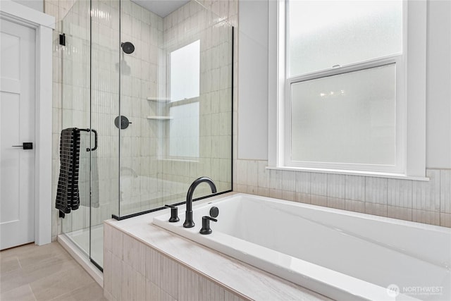 full bathroom with tile patterned floors, a shower stall, and a bath