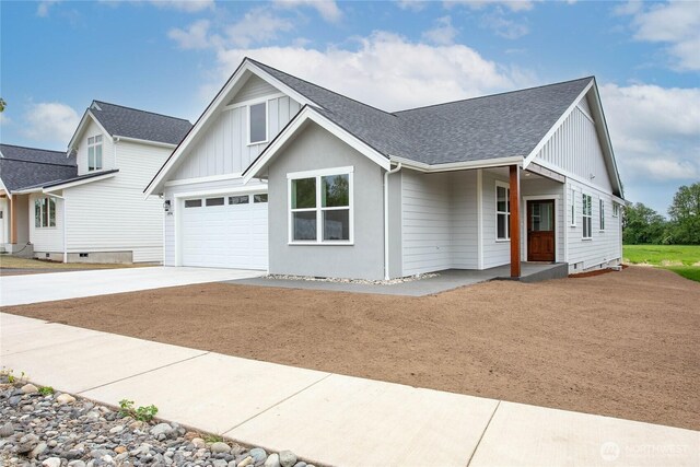 modern farmhouse featuring concrete driveway, board and batten siding, a shingled roof, and a garage
