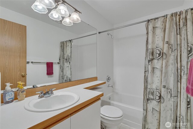 full bath with vanity, shower / bath combo with shower curtain, and toilet