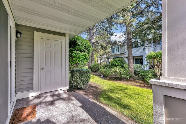 property entrance featuring a lawn