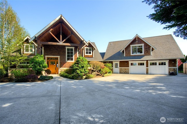 15089 Old Deception Mill Ln, Anacortes, WA 98221 - craftsman-style home with driveway, stone siding, and a garage