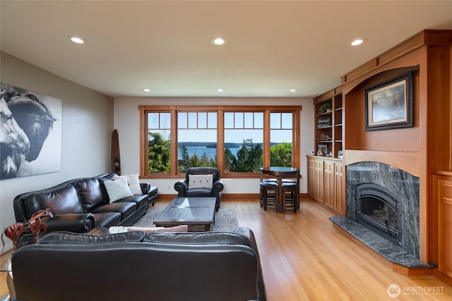 15089 Old Deception Mill Ln, Anacortes, WA 98221 - living area featuring light wood-style floors, recessed lighting, a healthy amount of sunlight, and a high end fireplace