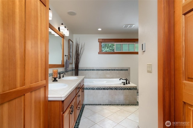15089 Old Deception Mill Ln, Anacortes, WA 98221 - bathroom with tile patterned flooring, a garden tub, visible vents, double vanity, and a sink
