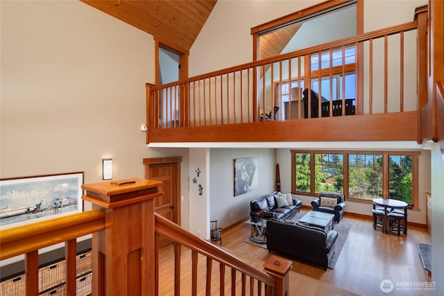 15089 Old Deception Mill Ln, Anacortes, WA 98221 - stairs with high vaulted ceiling, baseboards, wood ceiling, and wood finished floors